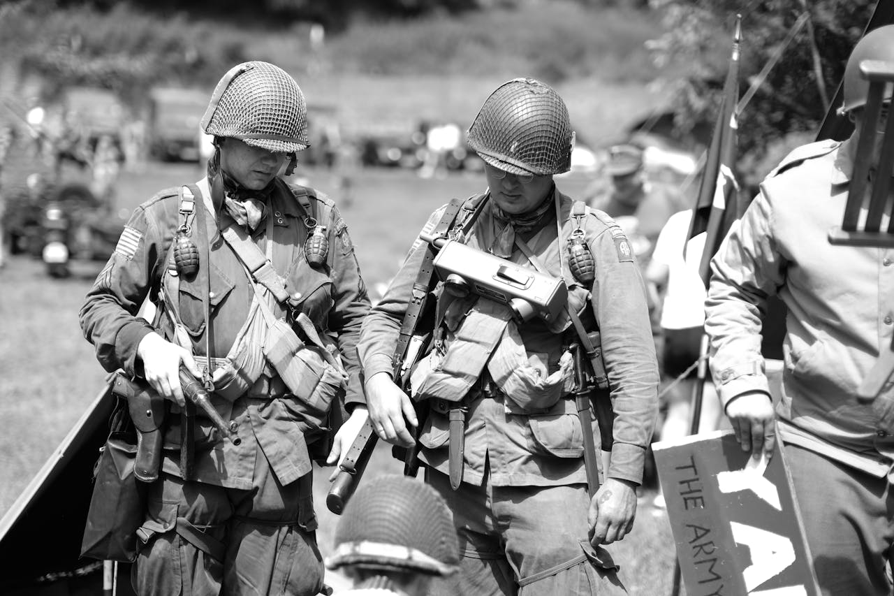 Black and white image of soldiers in military uniforms during a WWII reenactment.